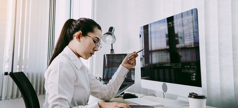 Asian woman professional development programming website working a software in office room.