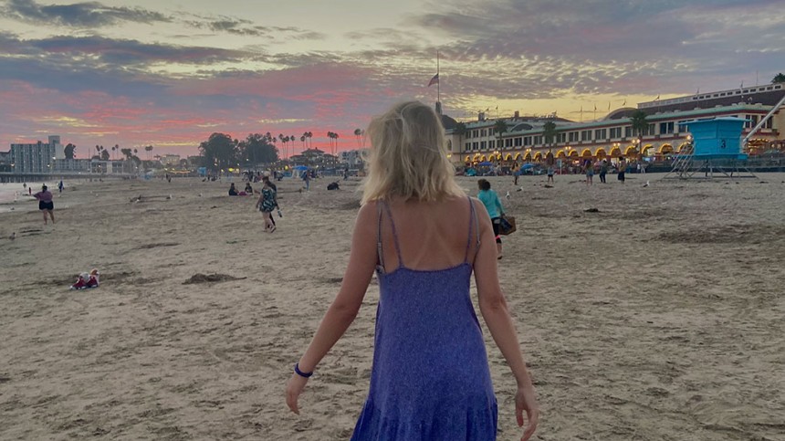 Rear view of Hannah Boettge walking on a beach 