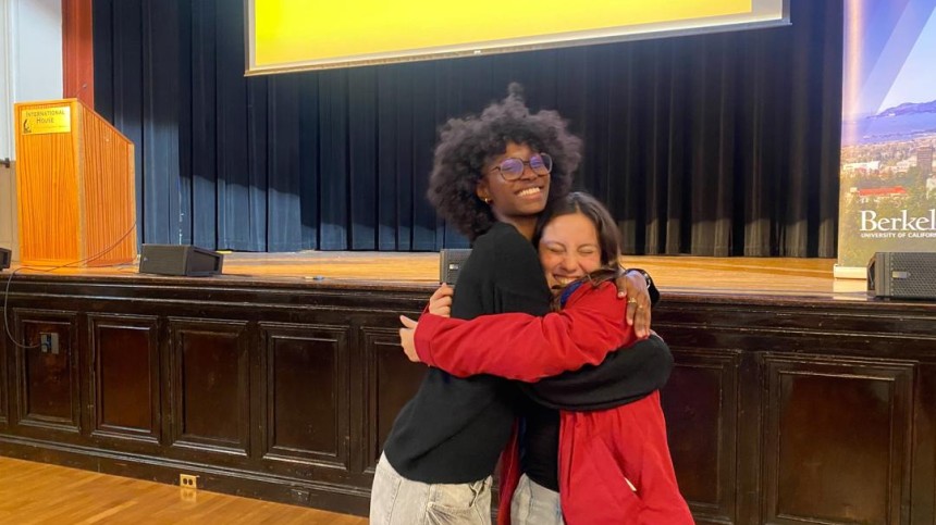 Mariane Iman Ndiaye and a friend share a hug at BGA closing ceremony