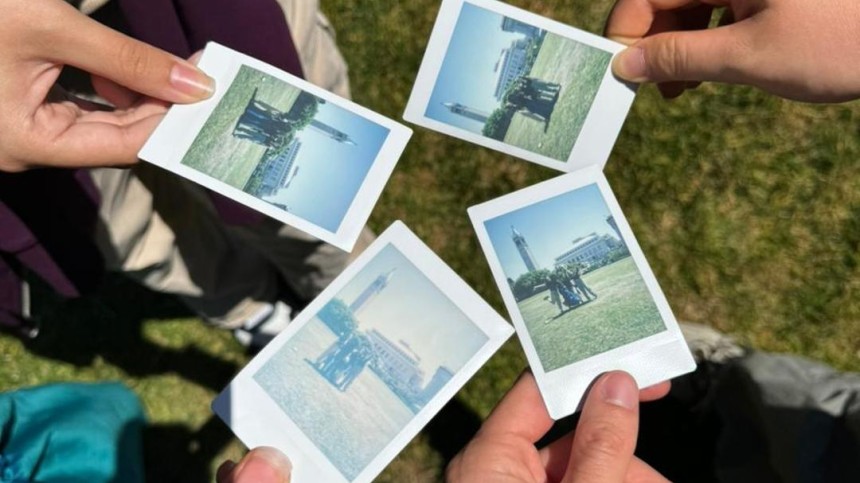 Mariane Iman Ndiaye and friends showing polaroid pictures