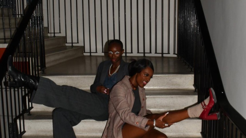 Mariane Iman Ndiaye and a friend pose on a staircase