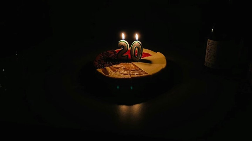 Photo of a birthday cake with numbers 20 on candles