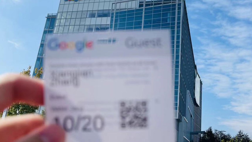 Photo of Xiangjian Zhang holding a pass to the Google building