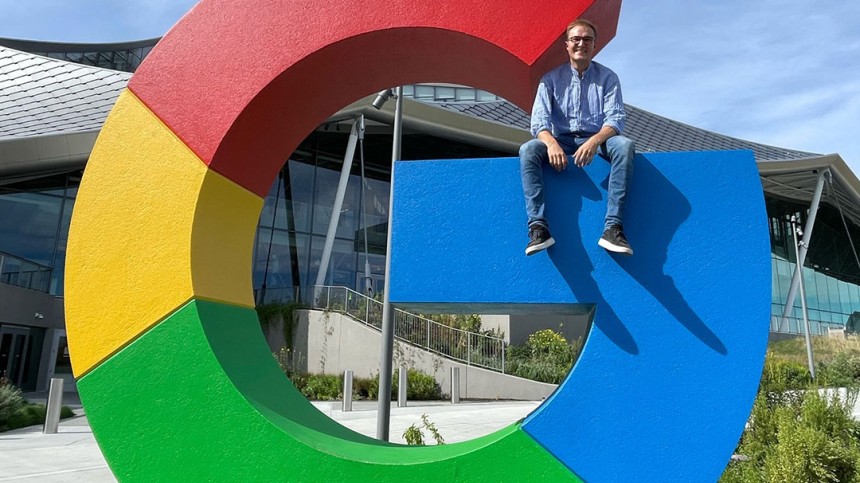 Sebastian Sartor sitting on the Google logo