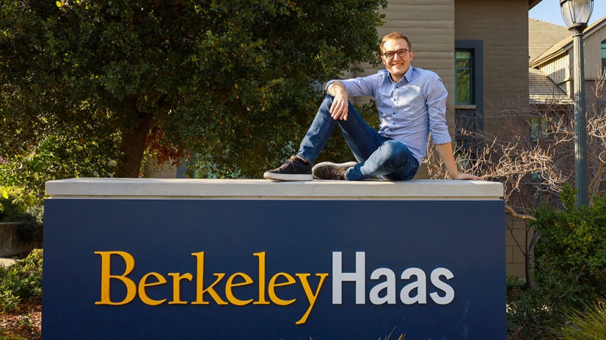 Sebastian Sartor sitting on top of Berkeley Haas sign