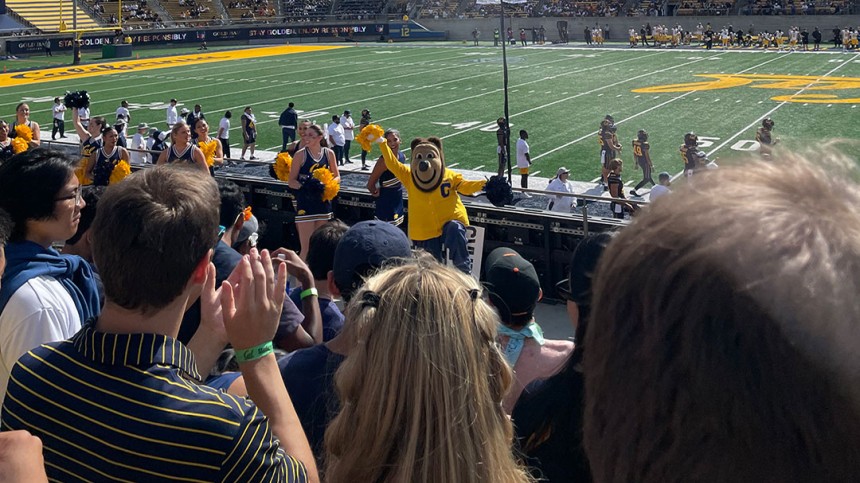 Photo of Cal Oski bear cheering at a football game