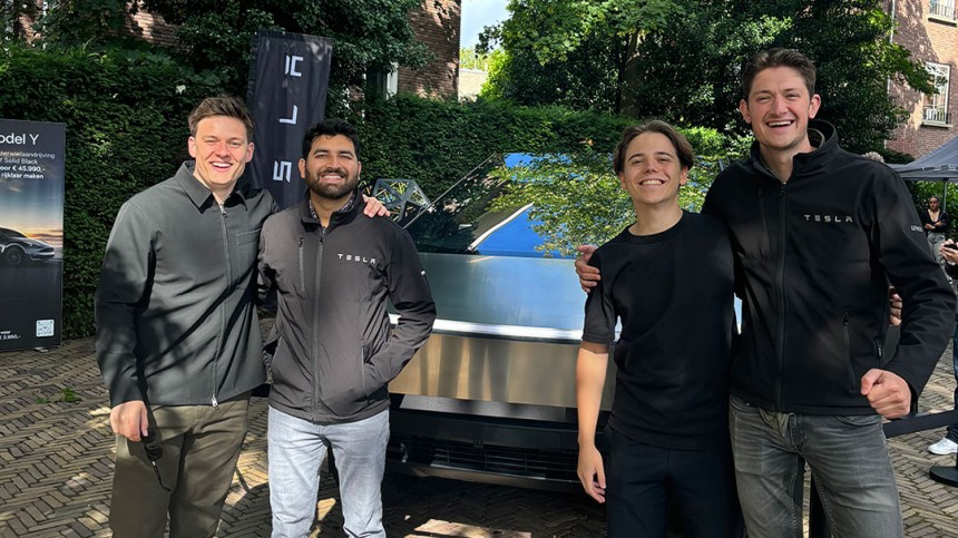 Wesley de Vries and friends stand in front of a Tesla smart car