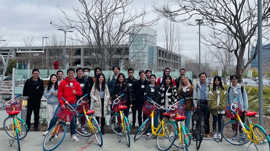 International students sit on Google bikes