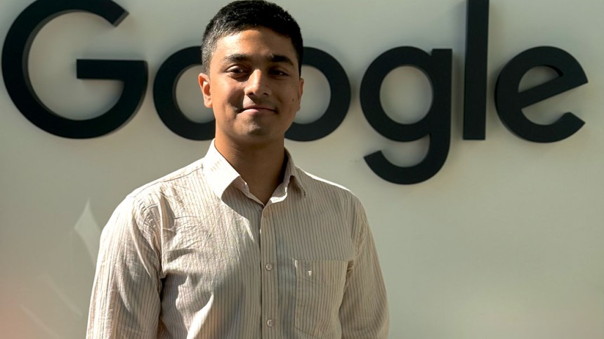 Tashrique Ahmed standing in front of Google sign